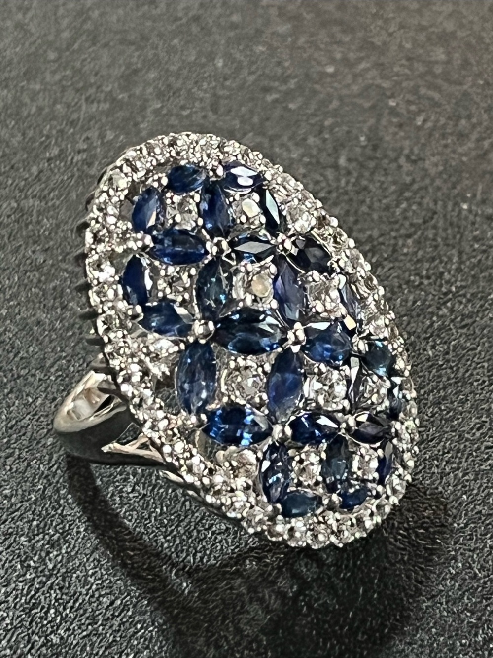 Sterling silver ring with blue and colorless stones in floral design. Sz 7.